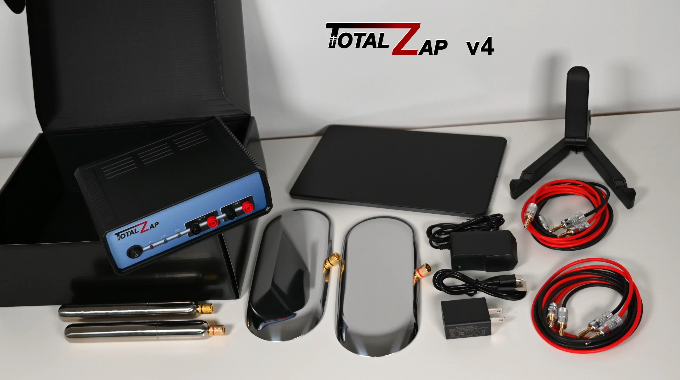 TotalZap complete package contents including frequency generator, tablet, electrodes, foot plates, cables and storage box